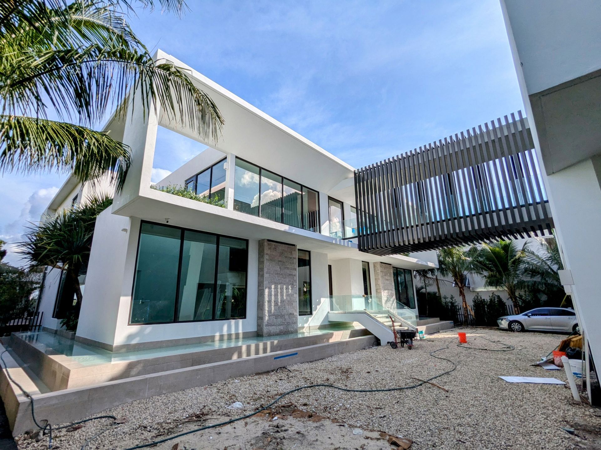 A large white house with a lot of windows is being built.