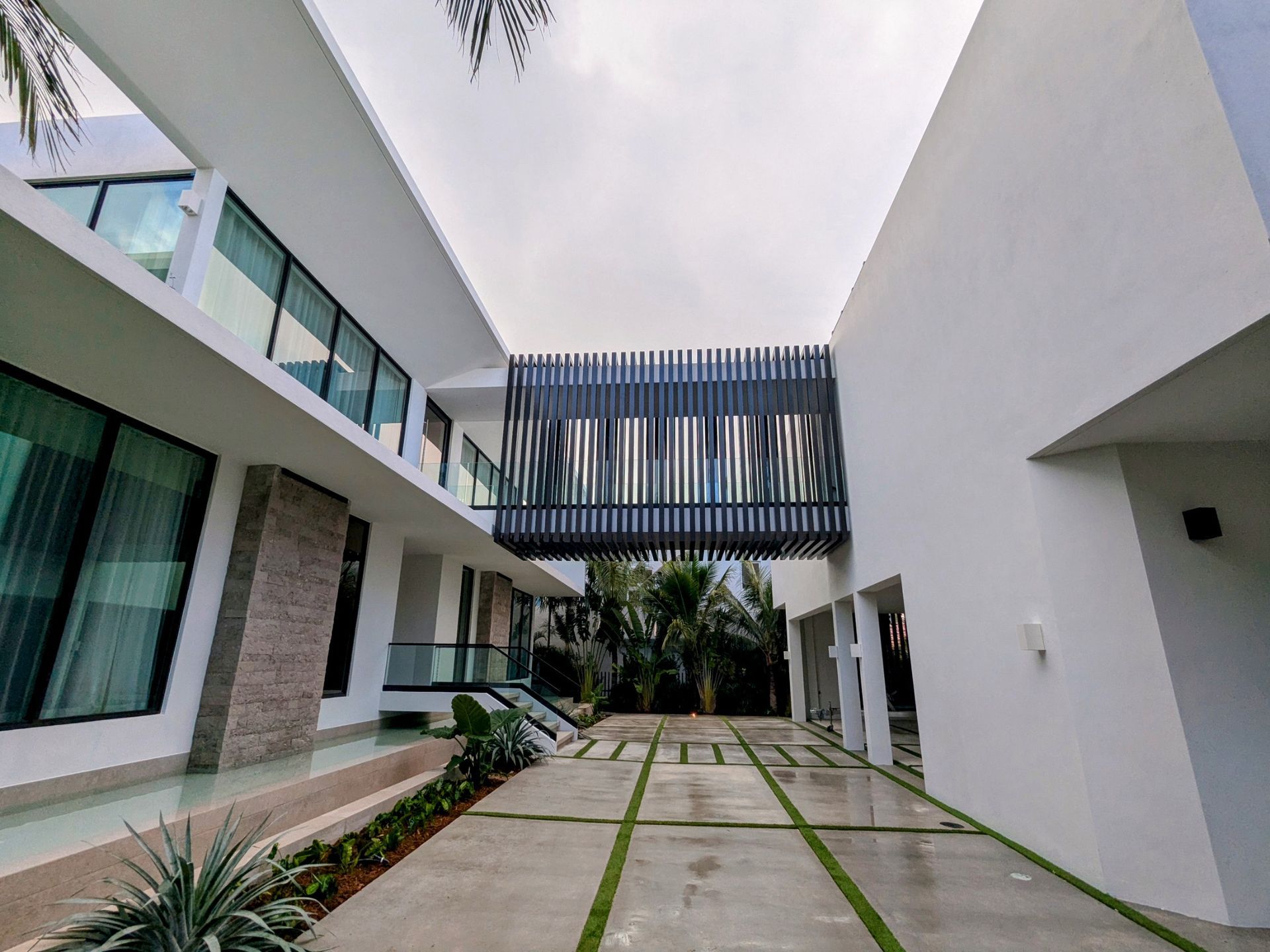 A large white building with a bridge between two buildings.