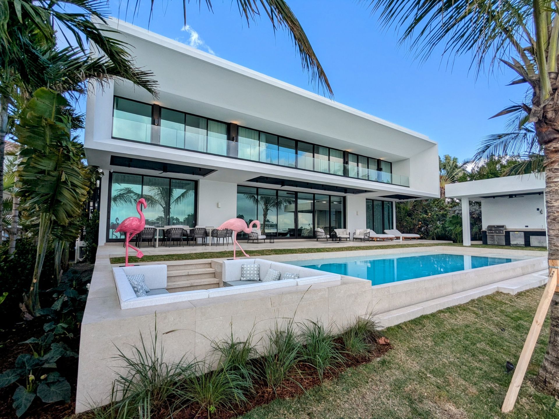 A large white house with a swimming pool in the backyard.