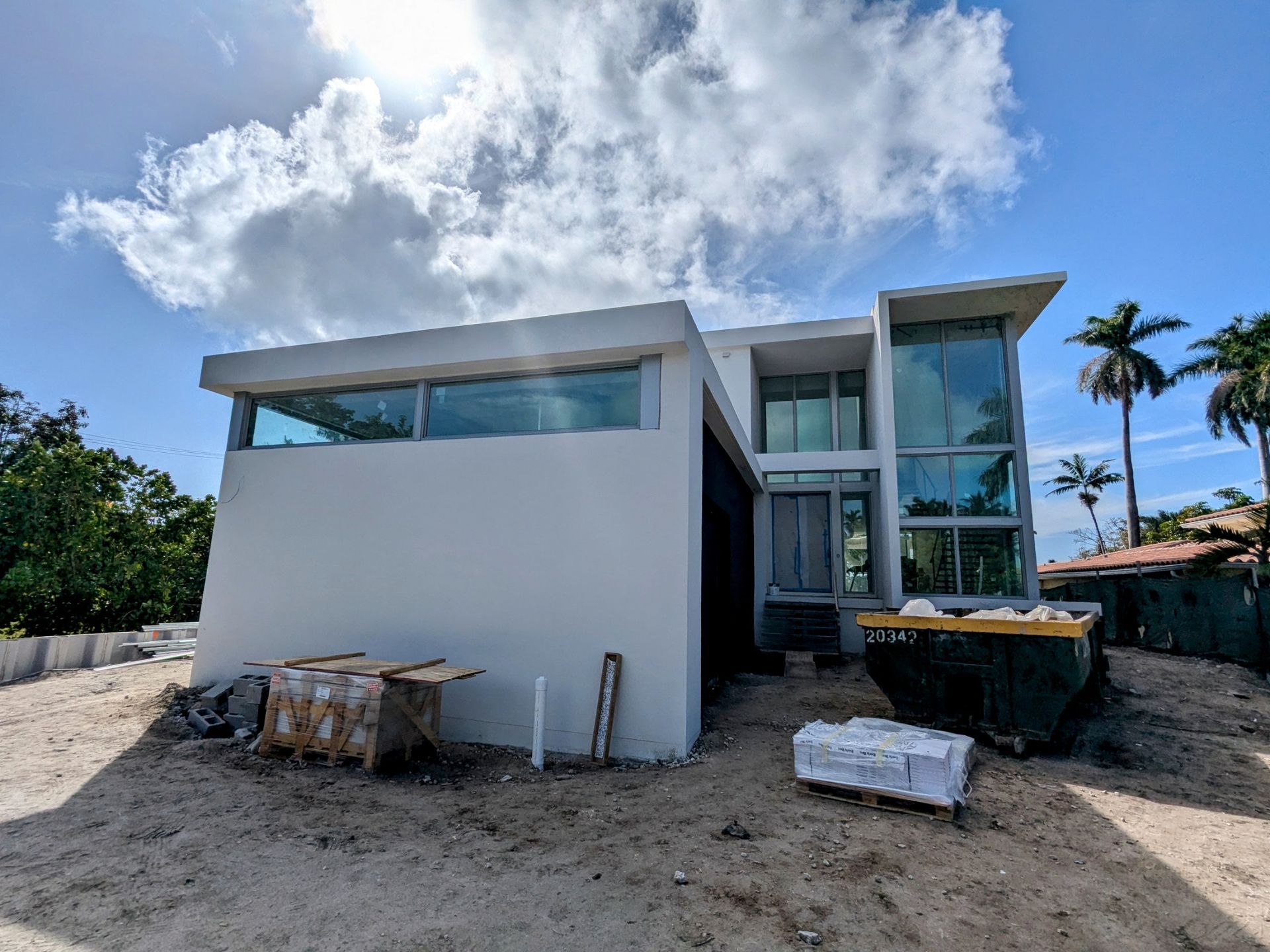 A large white house with a lot of windows is being built