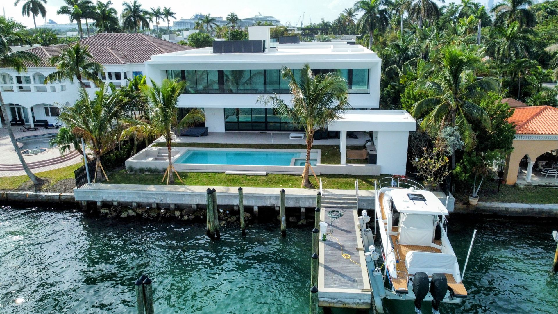 An aerial view of a house with a boat docked in front of it.