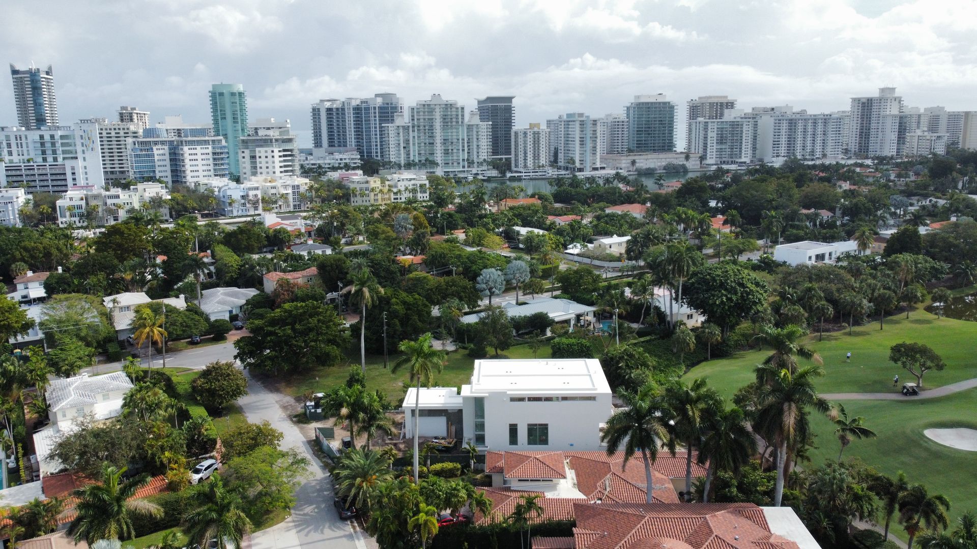An aerial view of a residential area with a city in the background