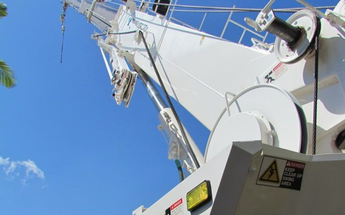 White Crane Transferring An Item To A Trailer