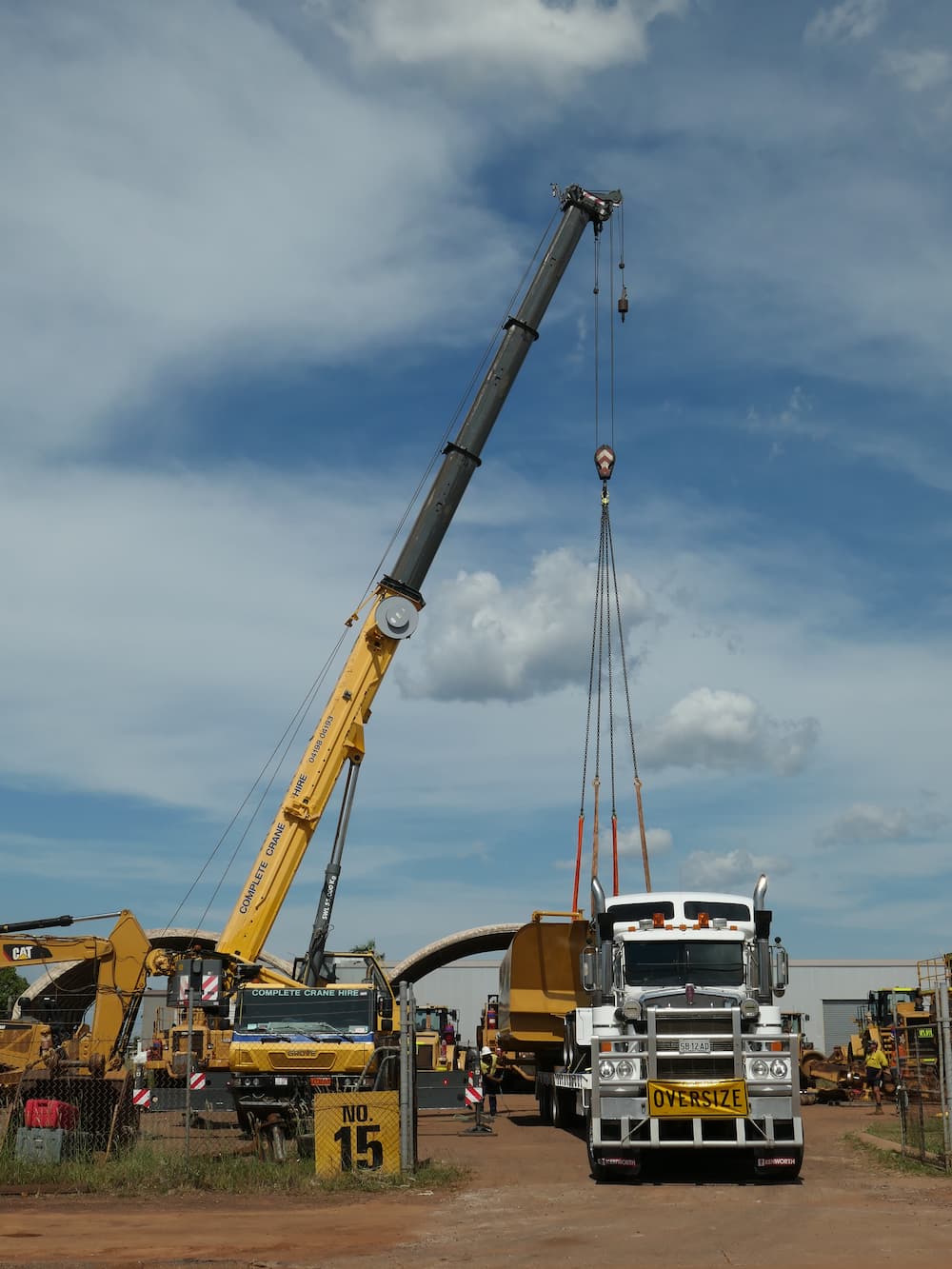 A Crane Getting Loads From A White Truck — Complete Crane Hire (NT) Pty Ltd in Pinelands, NT