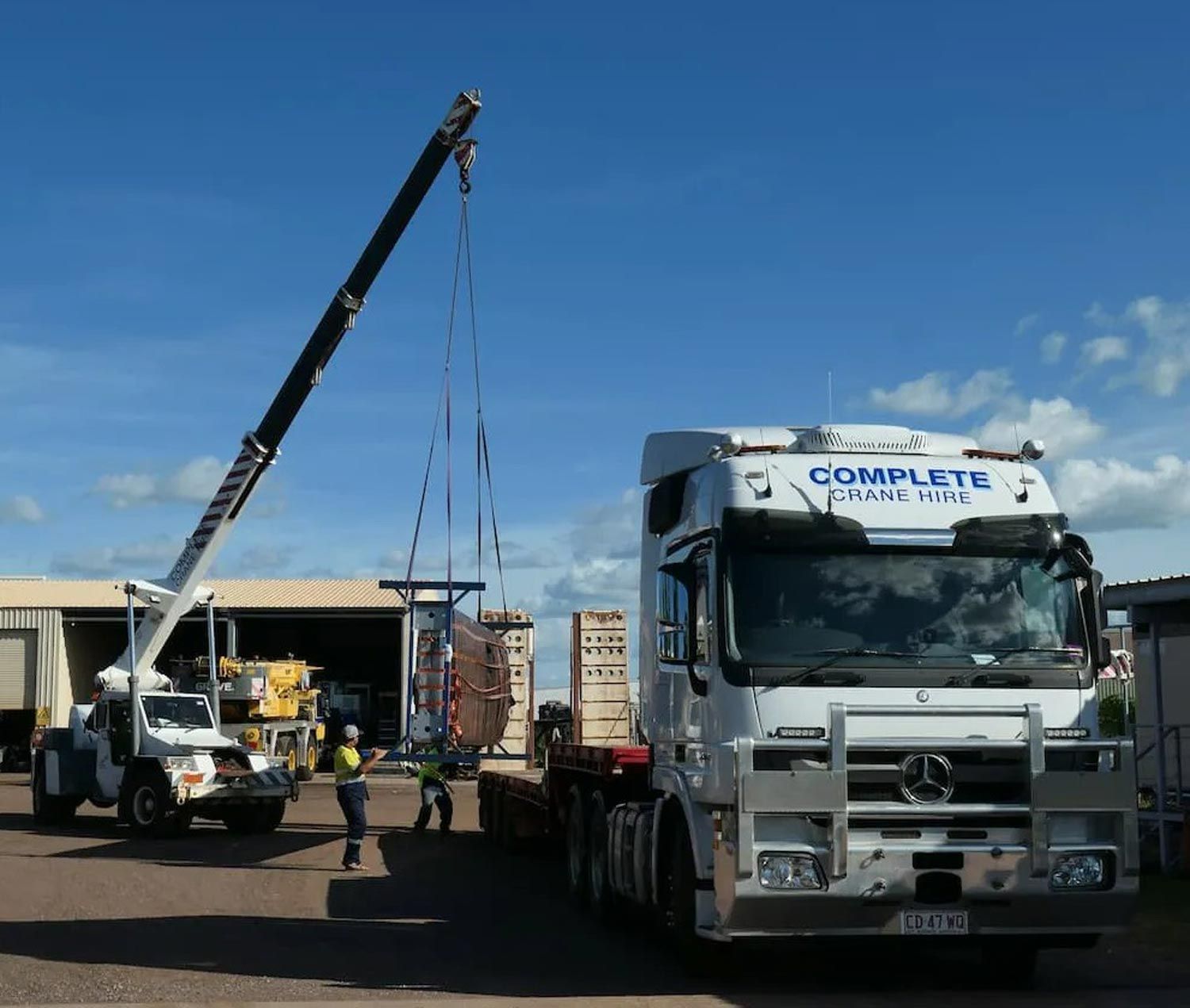White Crane Transferring An Item To A Trailer