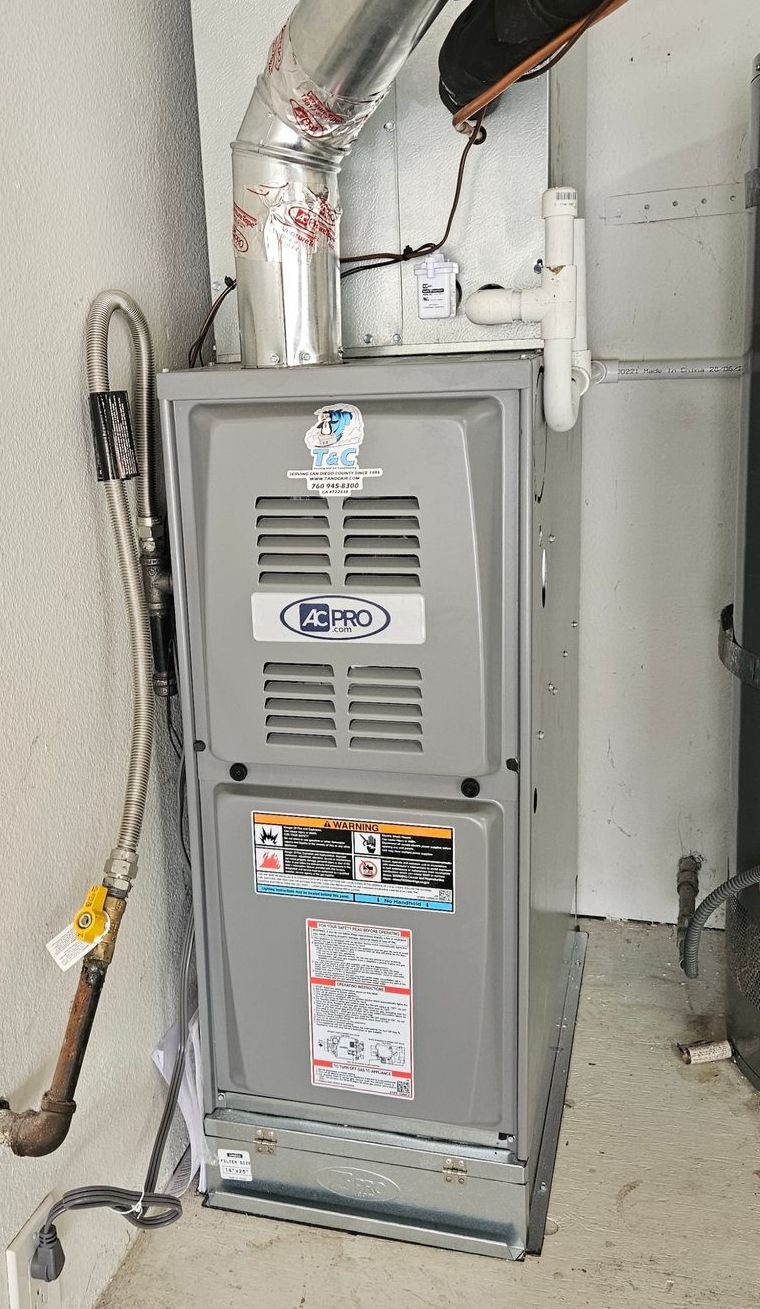 A Lennox furnace in a basement with a metal duct and gas line.