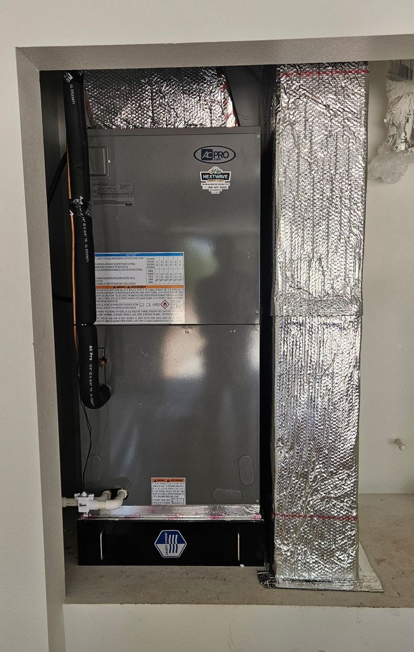 HVAC unit installed inside a recessed opening, with reflective insulation on the sides.