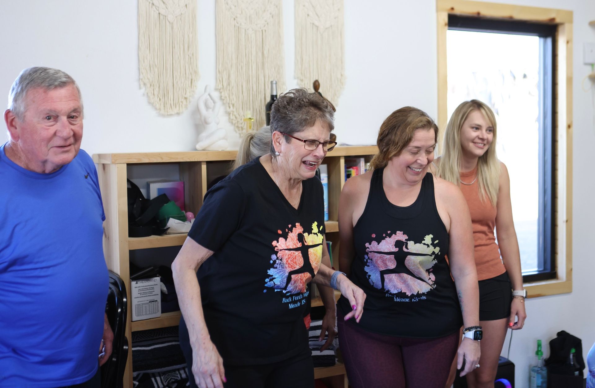 A group of people are standing next to each other in a room.