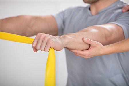 Physical Therapy — Man A Training With Exercise Band in Warren, OH