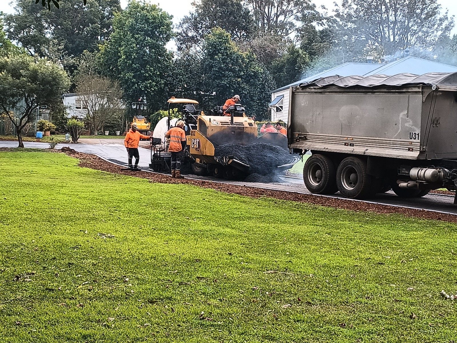 A group of people are working on a road.