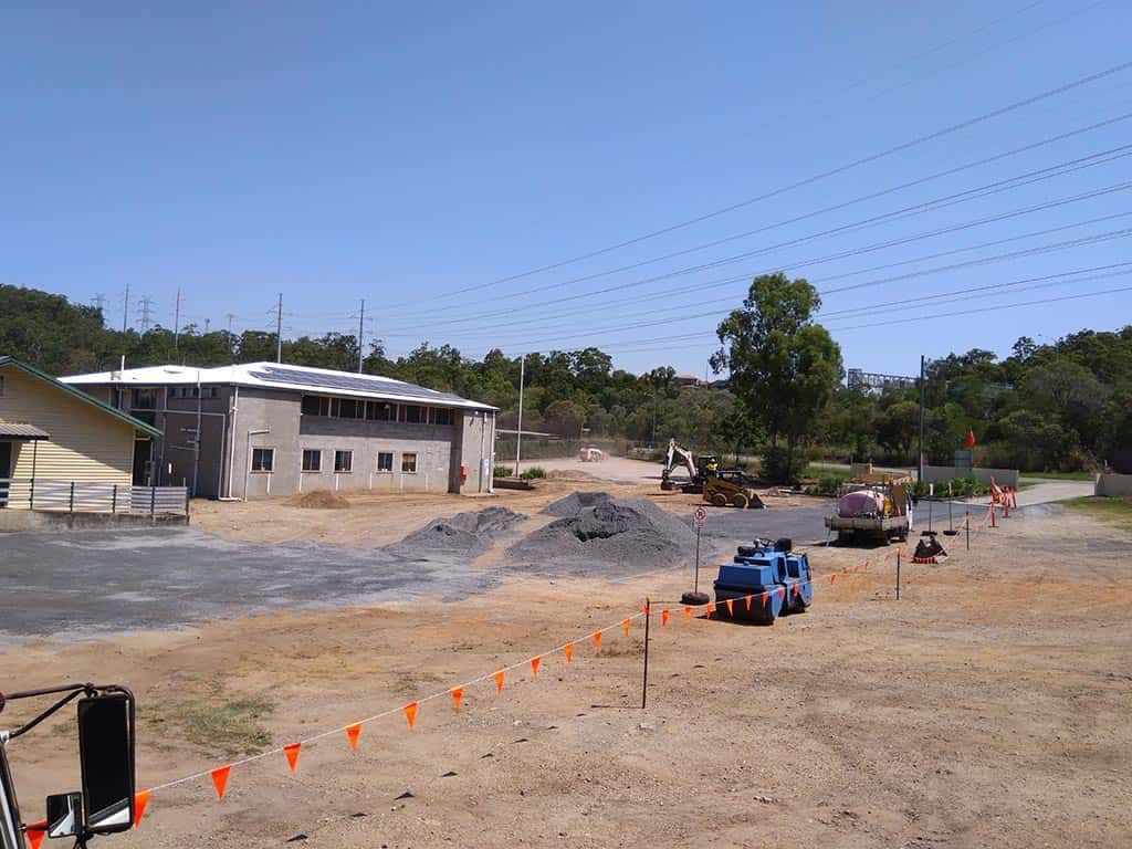 A large building with a lot of dirt in front of it