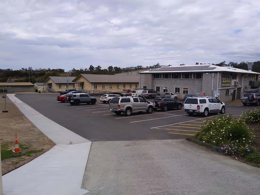 A lot of cars are parked in front of a building that says sun