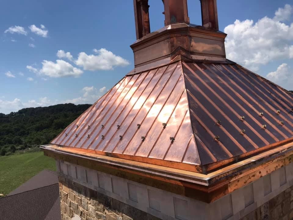 A copper roof with a chimney on top of it