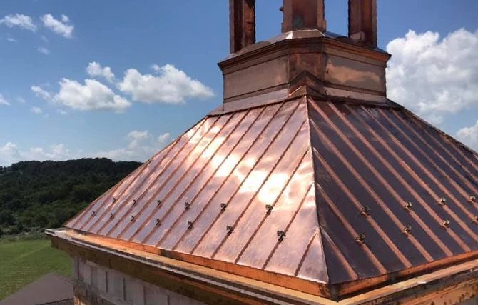 A copper roof with a chimney on top of it