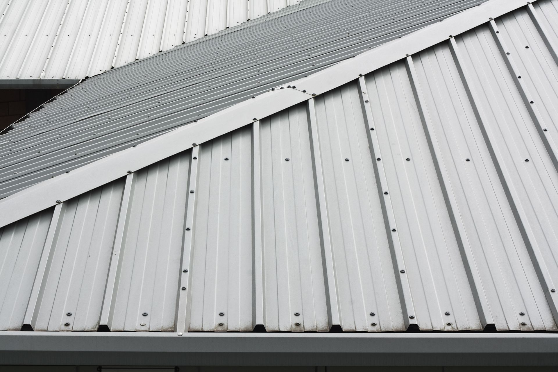 A close up of a white metal roof on a building.