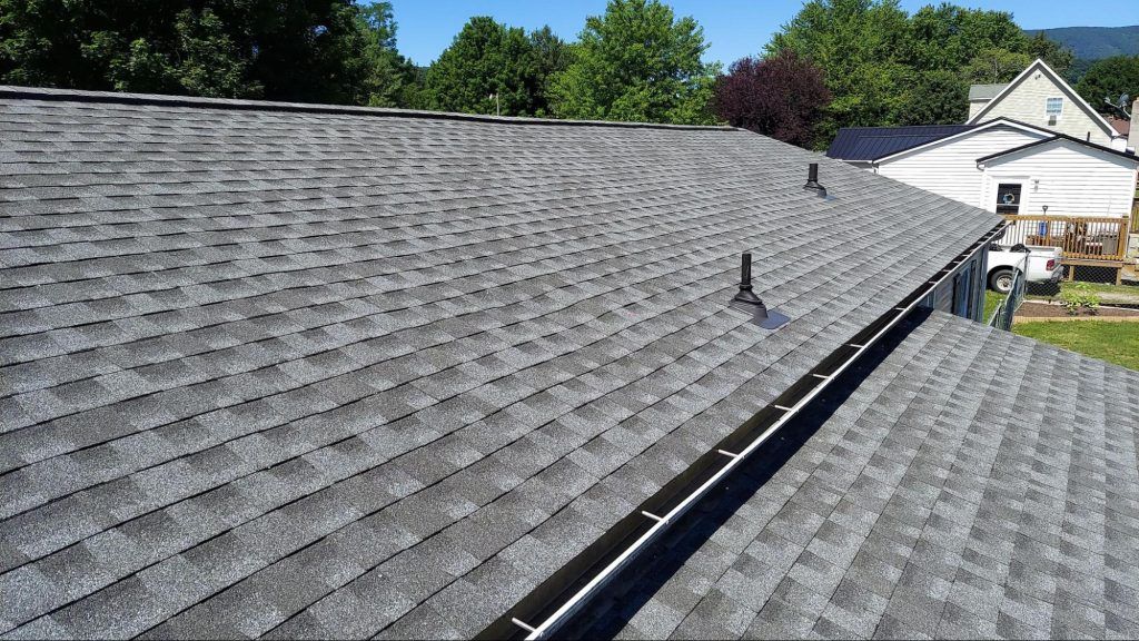 The roof of a house with a gutter on it.