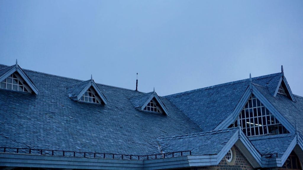 The roof of a building with a blue sky in the background.