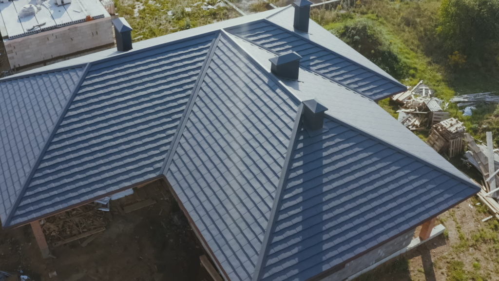 An aerial view of a house with a black roof.