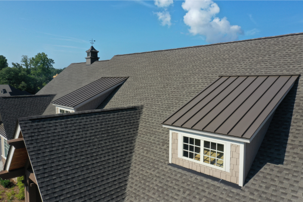 An aerial view of a house with a window on the roof