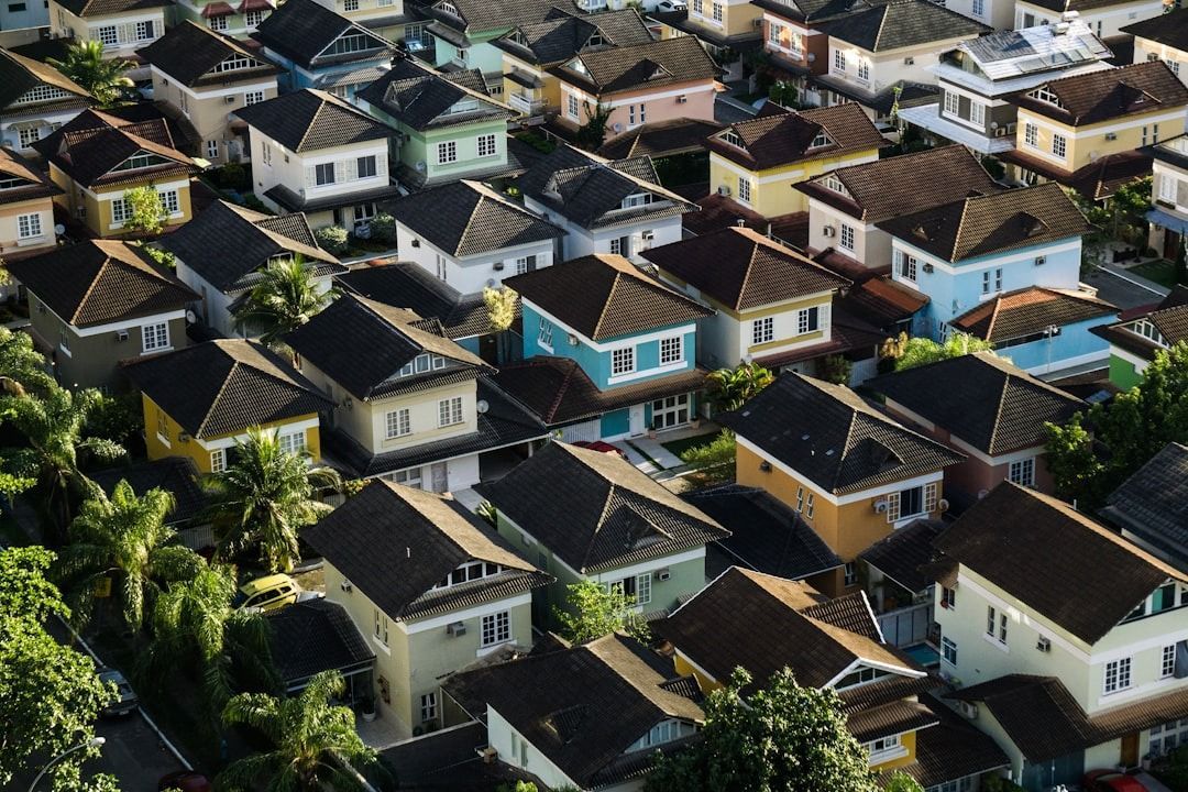 An aerial view of a residential area with lots of houses and trees.