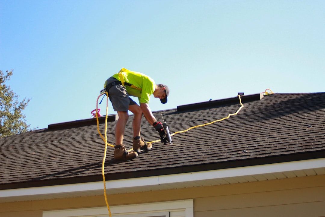 A man is working on the roof of a house.