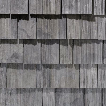 A close up of a wooden siding on a building.