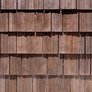 A close up of a wooden siding on a building.