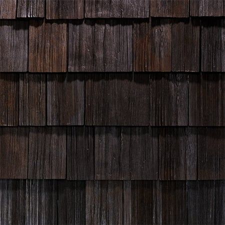A close up of a wooden roof with shingles.