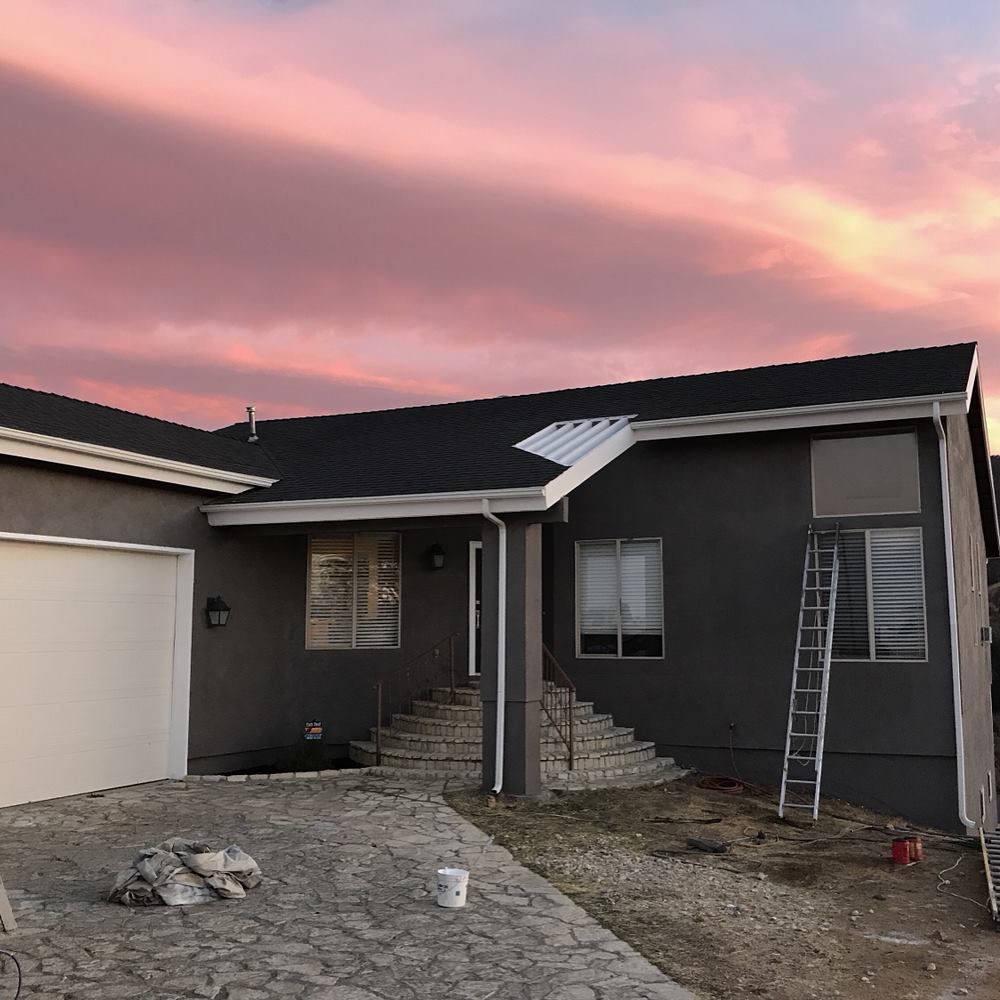 A house with a pink sky in the background