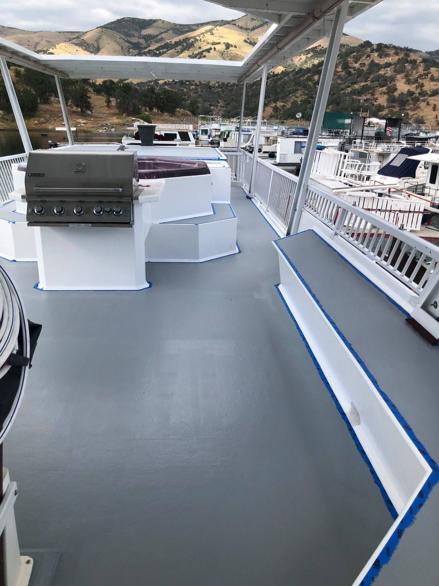 There is a grill on the deck of a boat.