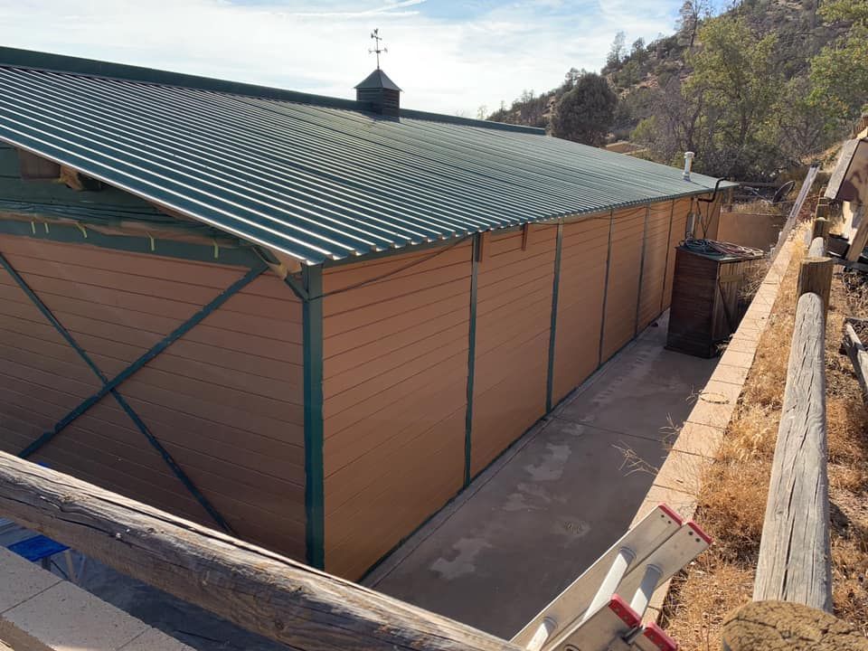 A large brown building with a green roof