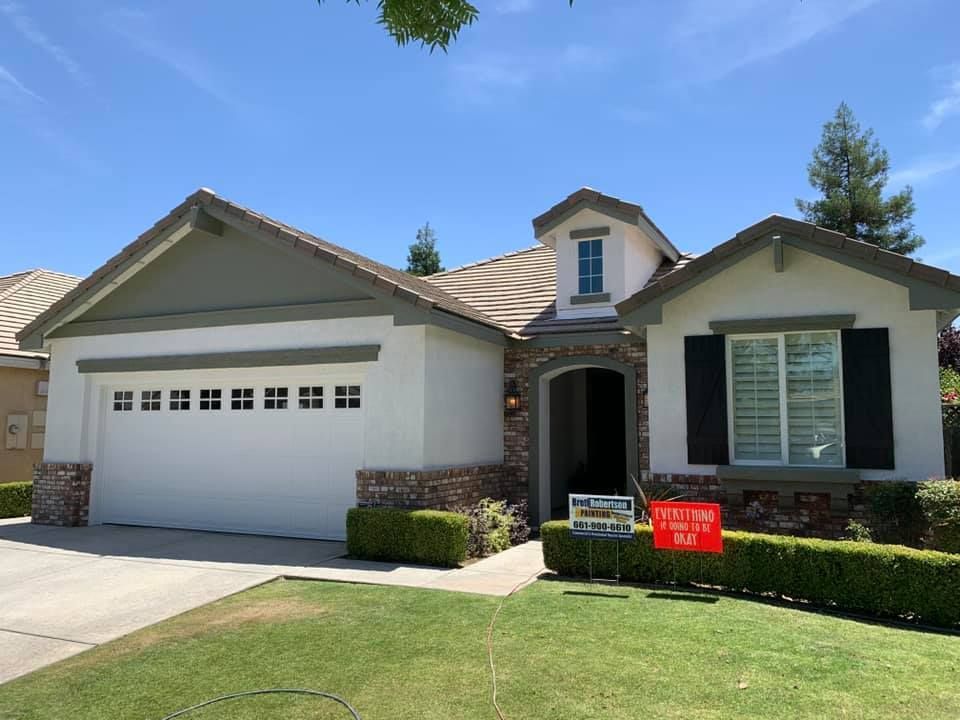 A white house with a for sale sign in front of it