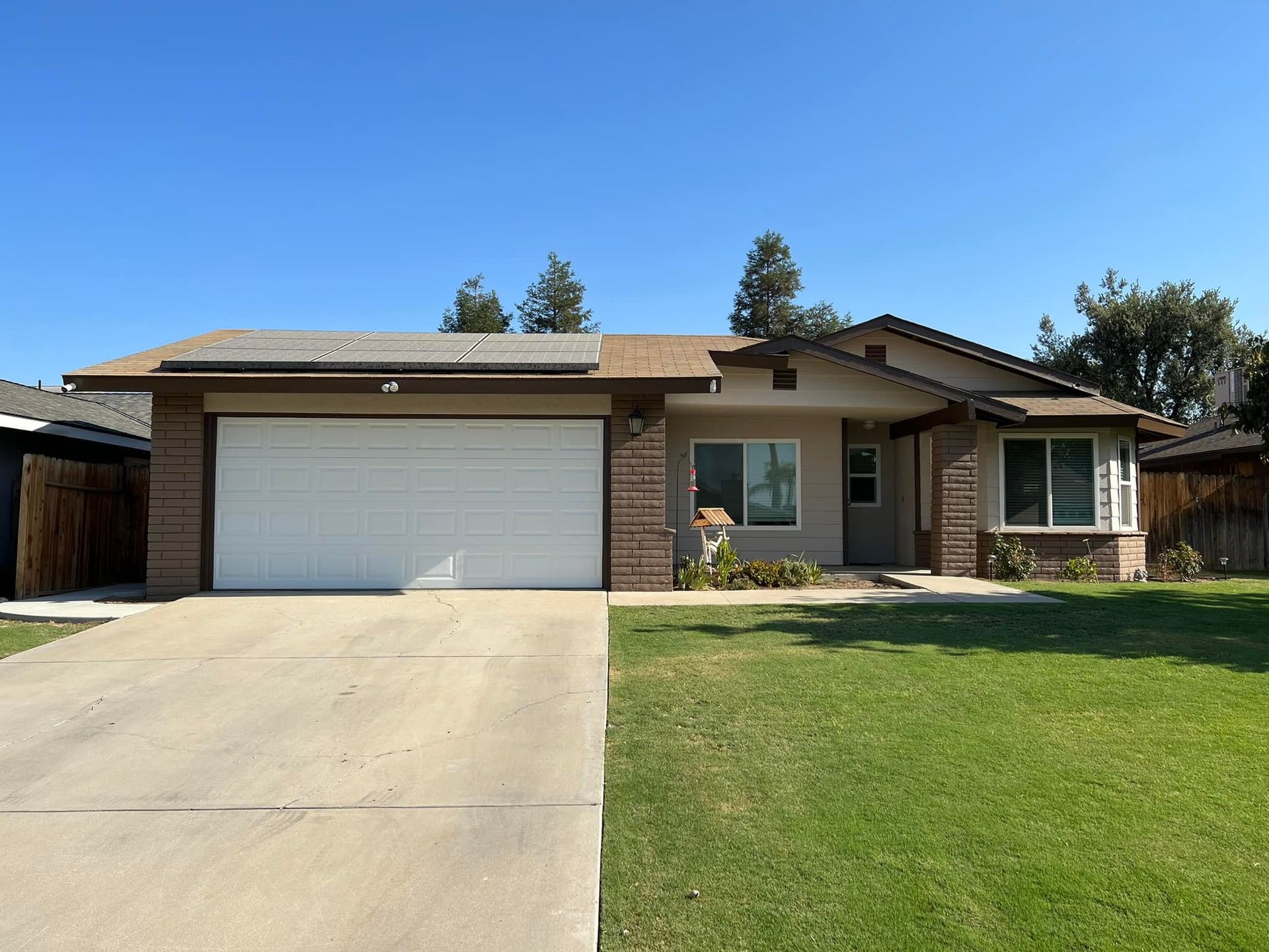 A house with a white garage door and a driveway