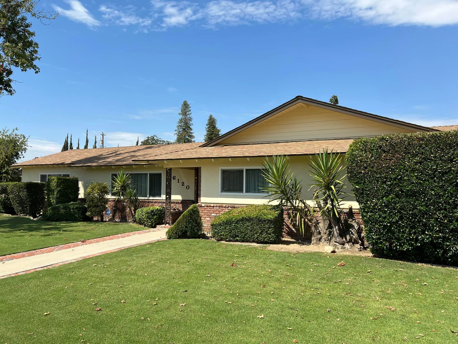 A large house with a lush green lawn in front of it.