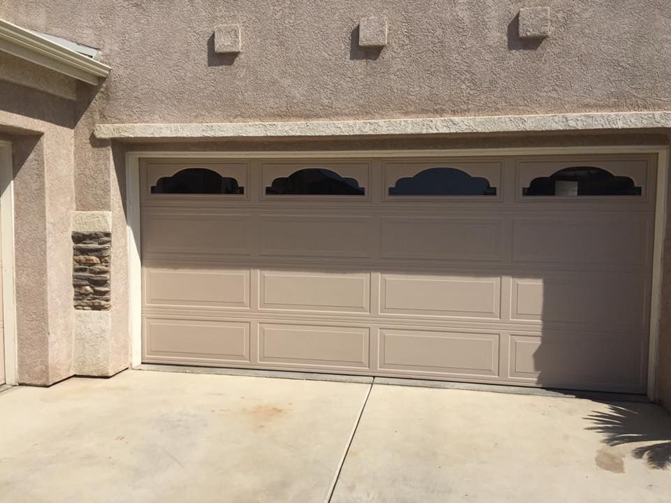 A tan garage door with a sign that says ' i love you ' on it