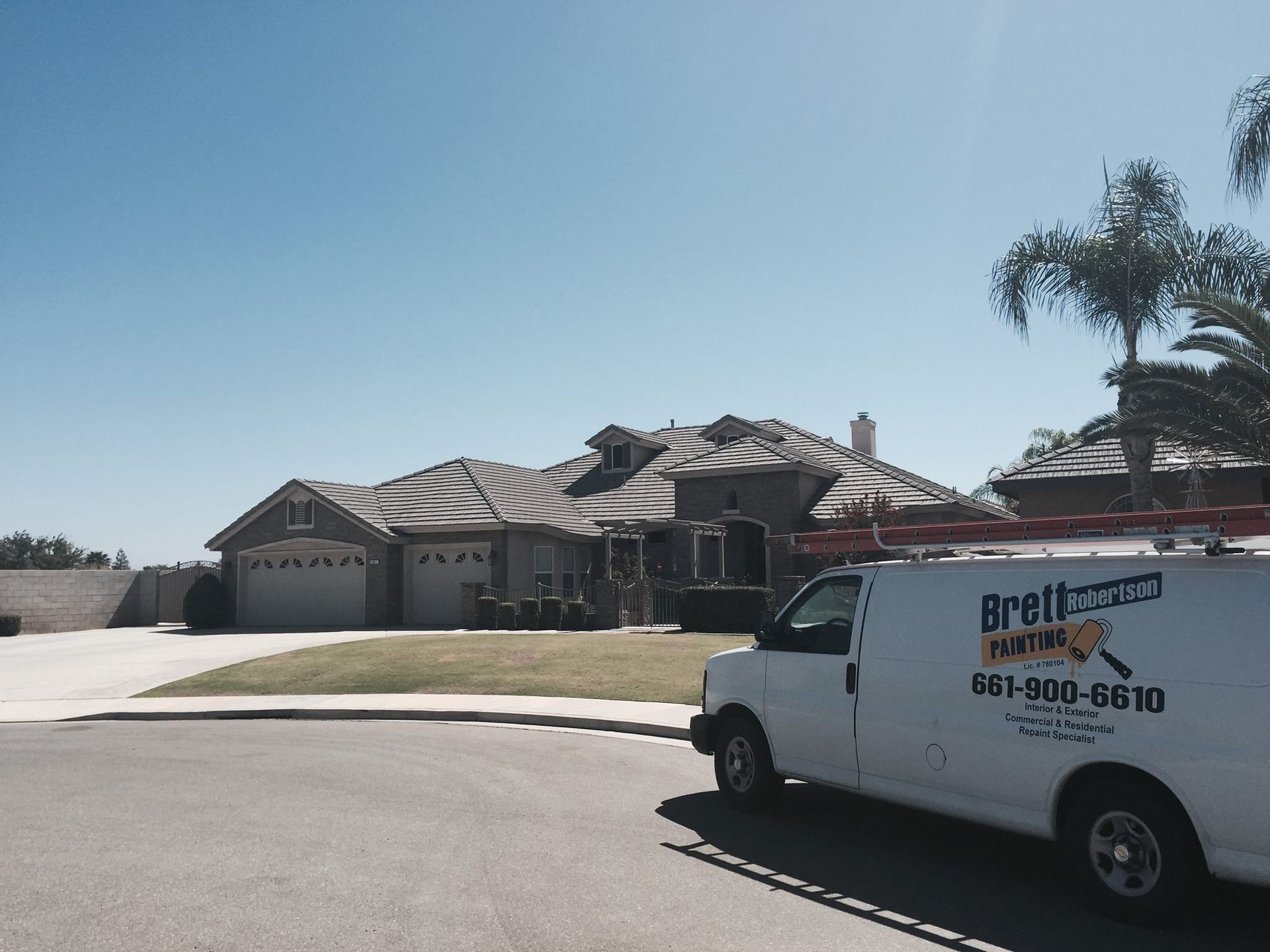 A white van is parked in front of a house