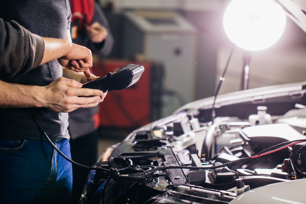 Two Men Working on a Car With the Hood Open in a Garage — Drinnan's Diesel & Automotive Repairs In Gladstone Central, QLD