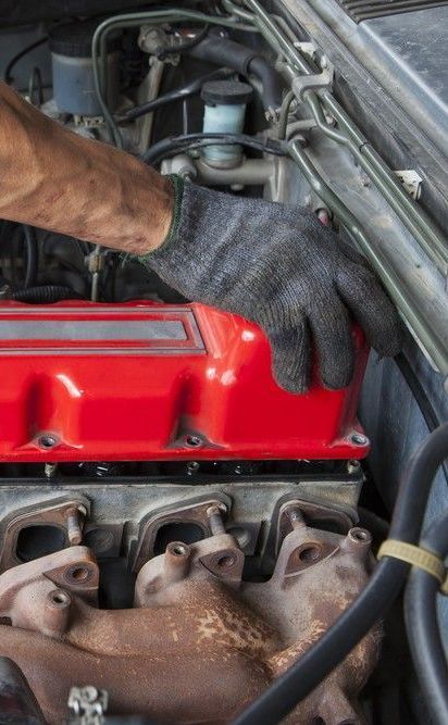 A Person is Working on the Engine of a Car — Drinnan's Diesel & Automotive Repairs In Gladstone Central, QLD