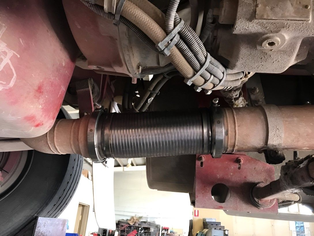 A Close Up of a Car Exhaust Pipe With a Hose Attached to It — Drinnan's Diesel & Automotive Repairs In Gladstone Central, QLD