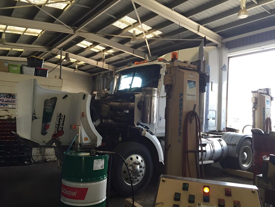A Truck is Sitting in a Garage Next to a Barrel of Castrol Oil — Drinnan's Diesel & Automotive Repairs In Gladstone Central, QLD