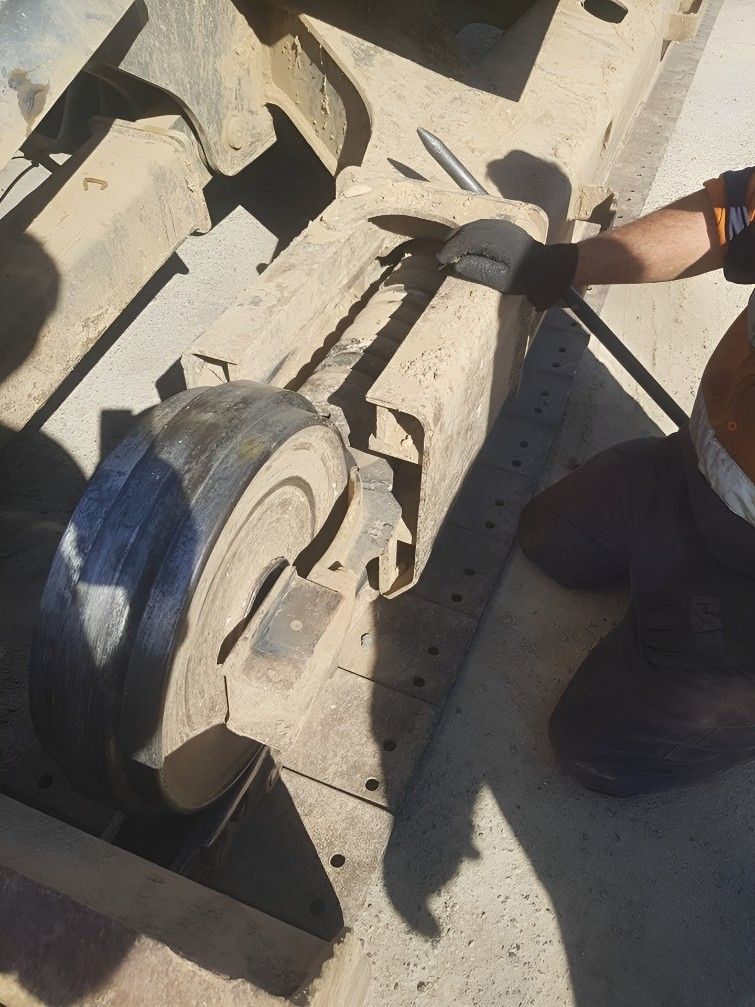 A Person Wearing Gloves is Working on a Piece of Equipment — Drinnan's Diesel & Automotive Repairs In Gladstone Central, QLD