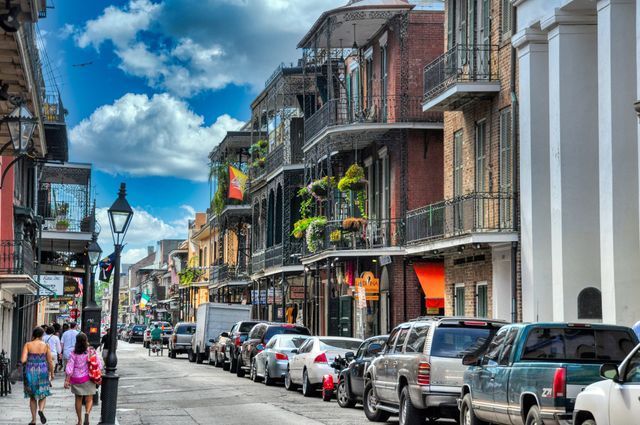 New Orleans' French Quarter with people walking and historic architecture lining the street