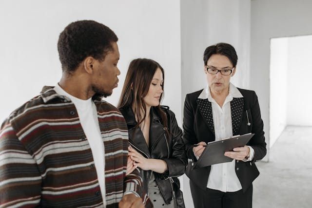 a landlord looking over a lease with two tenants
