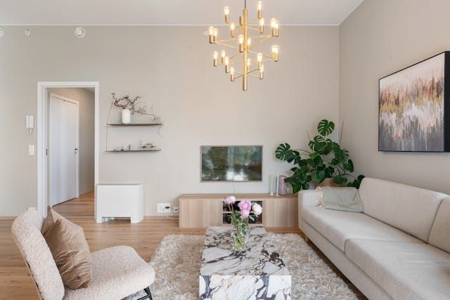 a-beige-living-room-with-light-food-floors-and-a-white-couch