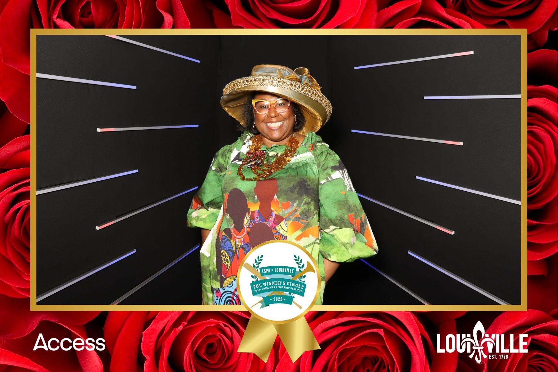 A woman in a hat is standing in front of red roses.