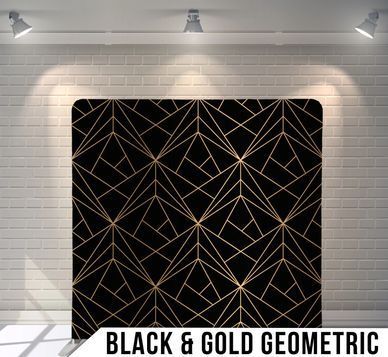 A black and gold geometric pattern on a brick wall