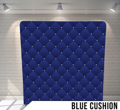 A blue cushion in front of a white brick wall