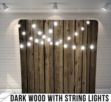 A dark wood background with string lights on it