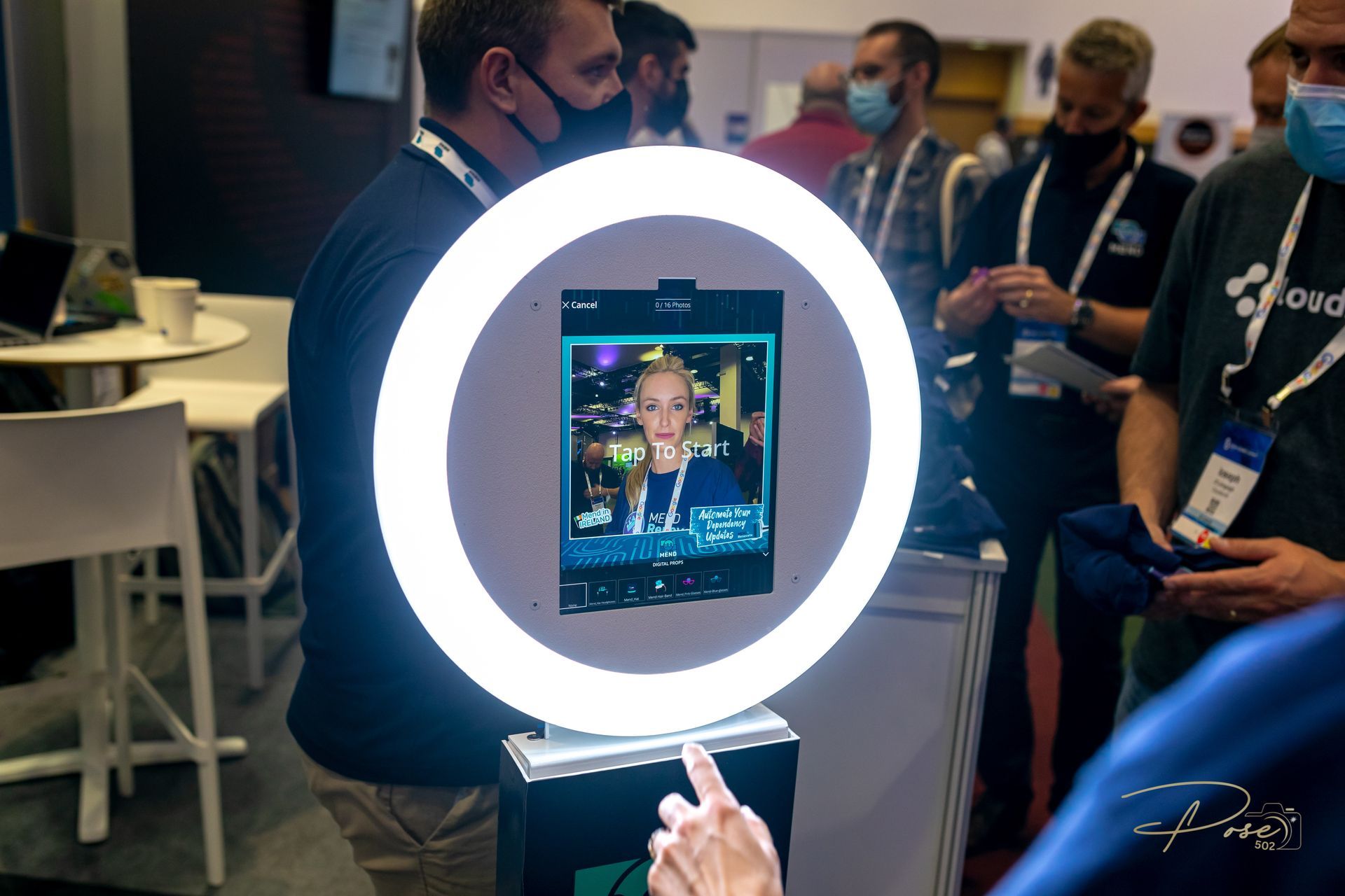 A man is taking a picture of himself in front of a ring light.