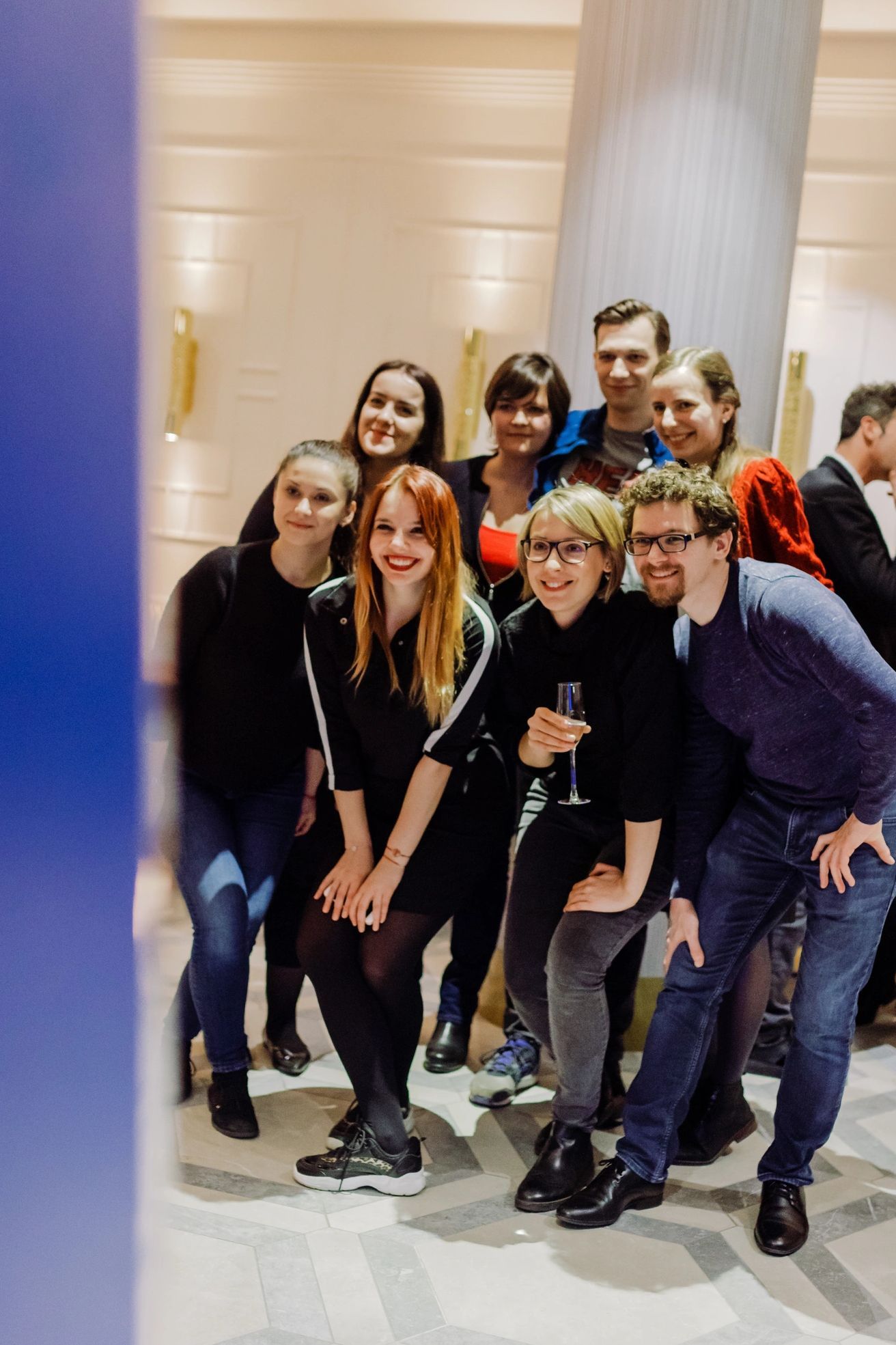 A group of people are posing for a picture in a room.